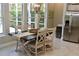 Bright dining area featuring a stylish table set with modern decor, complemented by natural light from large windows at 4901 Shoreline Cir, Sanford, FL 32771