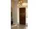 Elegant entryway showcasing a dark wood front door with sidelights and transom window, complemented by tile flooring at 4901 Shoreline Cir, Sanford, FL 32771