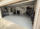 Spacious garage with epoxy flooring, shelving units, and ample storage space for tools and equipment at 4901 Shoreline Cir, Sanford, FL 32771