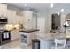 Spacious kitchen featuring a central island, stainless steel appliances, and ample storage within the white cabinetry at 4901 Shoreline Cir, Sanford, FL 32771