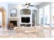 Inviting living room with a cozy fireplace, stylish decor, and large windows offering plenty of natural light at 4901 Shoreline Cir, Sanford, FL 32771