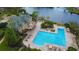A stunning aerial view of the community pool and amenity center overlooking the adjacent waterway at 4901 Shoreline Cir, Sanford, FL 32771