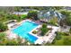 Aerial view of the community pool, hot tub, and amenity center with surrounding landscaping and parking at 4901 Shoreline Cir, Sanford, FL 32771