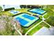 View of the community tennis and basketball courts and adjacent parking areas in a landscaped setting at 4901 Shoreline Cir, Sanford, FL 32771