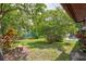 Landscaped backyard with vibrant plants and greenery provides a serene outdoor retreat at 5875 Talavera St, Orlando, FL 32807