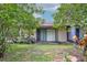 View of the backyard with a sliding glass door and lush trees creating a private space at 5875 Talavera St, Orlando, FL 32807