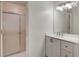 Well-maintained bathroom featuring a vanity with storage and a shower with sliding doors at 5875 Talavera St, Orlando, FL 32807