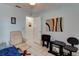 Cozy bedroom with a comfortable chair, tile floors, and a view of the hallway at 5875 Talavera St, Orlando, FL 32807