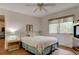 Bright bedroom with a large window, ceiling fan, and comfortable furnishings at 5875 Talavera St, Orlando, FL 32807