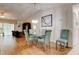 Bright dining area with glass table, chandelier, and hardwood floors at 5875 Talavera St, Orlando, FL 32807