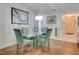 Stylish dining room with glass table, chandelier, and access to the hallway at 5875 Talavera St, Orlando, FL 32807
