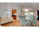 Elegant dining area with glass table, sideboard, and open view to the kitchen and living spaces at 5875 Talavera St, Orlando, FL 32807