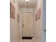 Inviting hallway features tiled flooring and decorative wall art at 5875 Talavera St, Orlando, FL 32807