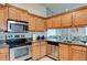 Well-equipped kitchen with stainless steel appliances, granite countertops, and ample cabinet space at 5875 Talavera St, Orlando, FL 32807