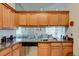 Charming kitchen with granite countertops, a stainless steel dishwasher, and ample cabinet space at 5875 Talavera St, Orlando, FL 32807