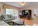 Bright living room with comfortable sofas, hardwood floors, and entertainment center at 5875 Talavera St, Orlando, FL 32807