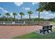 Community water feature with fountain, palm trees, bench, and manicured landscaping offering a serene setting at 8650 Lovett Ave, Orlando, FL 32832