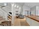 Bright living room with a soaring ceiling, a cozy fireplace, and staircase at 1663 Meadowgold Ct, Winter Park, FL 32792