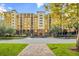 Luxury condo building with multiple floors, balconies, and ample parking at 8112 Poinciana Blvd # 1305, Orlando, FL 32821