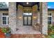 Close-up of a home's entryway with brickwork, double doors, and decorative plants at 250 Shady Oaks Cir, Lake Mary, FL 32746