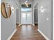 Bright entryway with double doors, hardwood floors, and elegant wall sconces at 250 Shady Oaks Cir, Lake Mary, FL 32746