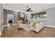 Open living room showcasing hardwood floors, a fireplace, and an adjacent bedroom at 250 Shady Oaks Cir, Lake Mary, FL 32746