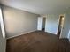 Bedroom with neutral paint and floors, with views to the bathroom and closet at 4642 Commander Dr # 933, Orlando, FL 32822