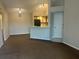 Open concept living space with a kitchen bar, wood cabinets and neutral walls and floors at 4642 Commander Dr # 933, Orlando, FL 32822
