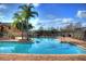 Large pool with brick patio and lounging area, perfect for relaxation and recreation at 4642 Commander Dr # 933, Orlando, FL 32822
