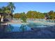Beautifully maintained pool area with ample seating and palm trees, offering resort-style living at 4642 Commander Dr # 933, Orlando, FL 32822