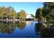 Scenic water view showcases a beautiful lake surrounded by lush trees, and an attractive building in the background at 4642 Commander Dr # 933, Orlando, FL 32822