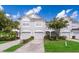 Two-story townhome with attached garage and landscaped yard at 15223 Windmill Harbor Ct, Orlando, FL 32828