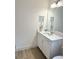 Clean bathroom boasts a white vanity with a quartz countertop at 3201 Songbird Cir, Harmony, FL 34773