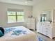 Bedroom with white dresser and large window at 3201 Songbird Cir, Harmony, FL 34773