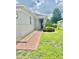 Side view of house showcasing a walkway and landscaping at 3201 Songbird Cir, Harmony, FL 34773