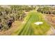 Aerial view of a golf course with a cart on the fairway at 3201 Songbird Cir, Harmony, FL 34773