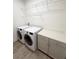 Laundry room with white washer and dryer and built-in cabinets at 3201 Songbird Cir, Harmony, FL 34773