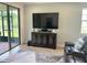 Living area with large TV, built-in cabinet, and comfy seating at 3201 Songbird Cir, Harmony, FL 34773