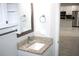 Bathroom with granite vanity and view of kitchen at 1148 Bancroft St, Deltona, FL 32725
