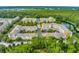 Gorgeous aerial view of the condo community nestled amongst green trees and lush landscaping at 1401 Celebration Ave # 402, Celebration, FL 34747