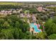 Overhead shot of community pool and amenity center surrounded by lush landscaping and residences at 1401 Celebration Ave # 402, Celebration, FL 34747