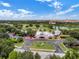 Elevated shot of a golf clubhouse and course featuring manicured landscaping and mature trees at 1401 Celebration Ave # 402, Celebration, FL 34747