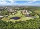 Wide aerial of a lush golf course with water features and residences in a suburban setting at 1401 Celebration Ave # 402, Celebration, FL 34747