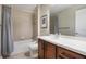 Well-lit bathroom features a shower-tub combo with a decorative tile backsplash at 1401 Celebration Ave # 402, Celebration, FL 34747