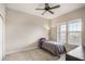 Bedroom with a large window and ceiling fan at 1401 Celebration Ave # 402, Celebration, FL 34747