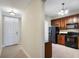 A split view from foyer shows the kitchen with dark cabinetry and black appliances at 1401 Celebration Ave # 402, Celebration, FL 34747