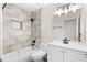 Modern bathroom featuring a tub with tiled walls and a vanity with a large mirror at 2026 Travelers Palm Dr, Edgewater, FL 32141