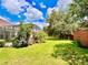 Landscaped backyard featuring a pool, cabana, and lush green lawn at 6533 Cartmel Ln, Windermere, FL 34786