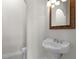 Elegant powder room with pedestal sink and ornate mirror at 6533 Cartmel Ln, Windermere, FL 34786