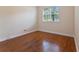 Simple bedroom with hardwood floors and a window with natural light at 6533 Cartmel Ln, Windermere, FL 34786